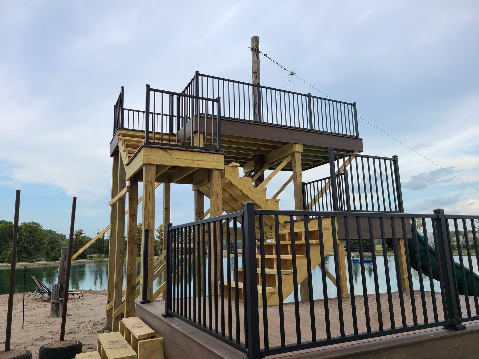 Custom lakeside deck tower with stairs and composite decking