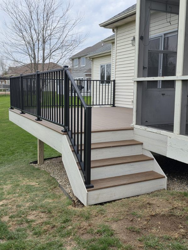 Two tone composite deck with black aluminum railing and wide steps in Northern Indiana