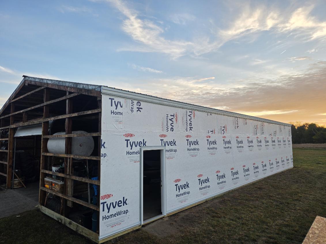 Pole barn re-side project with Tyvek HomeWrap installed before new metal siding