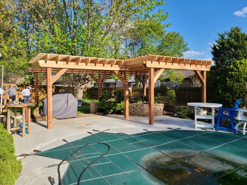 Large custom cedar pergola built over a poolside patio