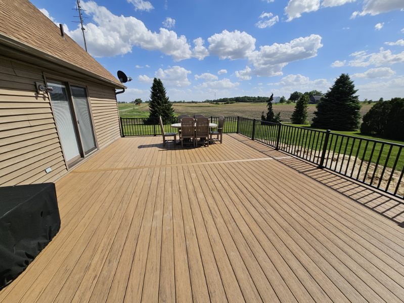 Wide composite deck with countryside views and black aluminum railing