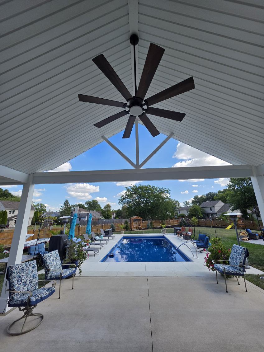 Vaulted poolside pavilion with tongue and groove ceiling and large ceiling fan